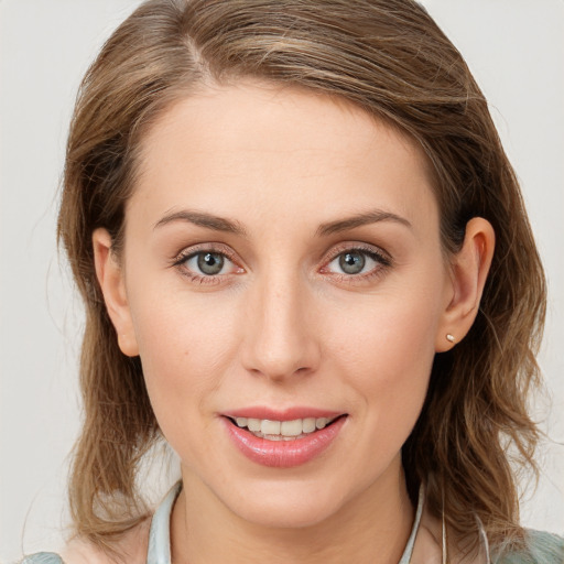 Joyful white young-adult female with medium  brown hair and blue eyes