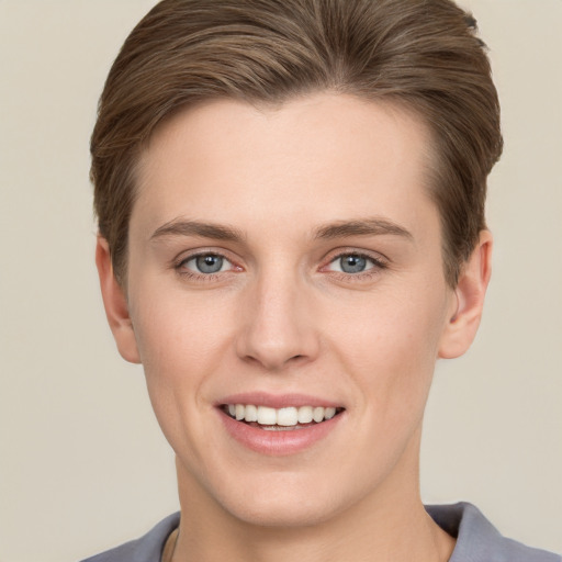 Joyful white young-adult female with short  brown hair and grey eyes