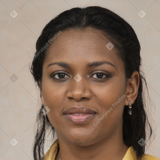 Joyful black young-adult female with long  brown hair and brown eyes