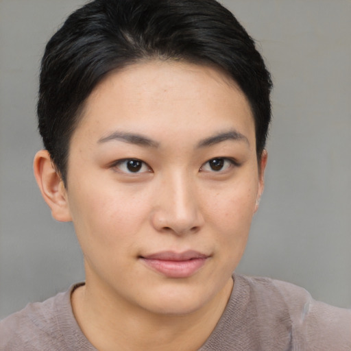 Joyful asian young-adult female with short  brown hair and brown eyes