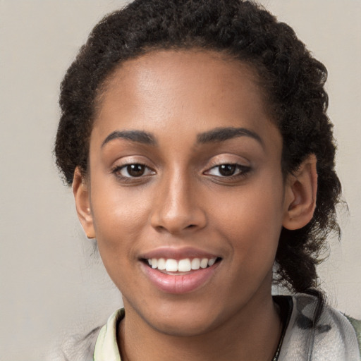 Joyful white young-adult female with long  black hair and brown eyes