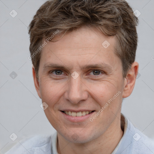 Joyful white adult male with short  brown hair and grey eyes