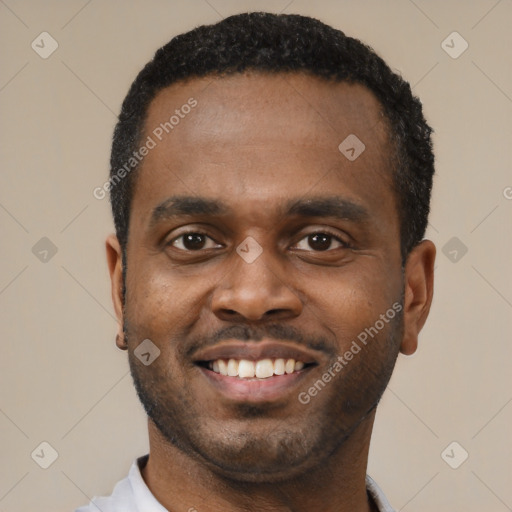 Joyful black young-adult male with short  black hair and brown eyes