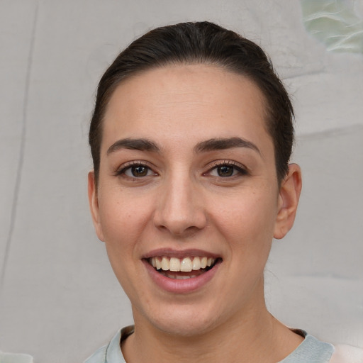 Joyful white young-adult female with short  brown hair and brown eyes