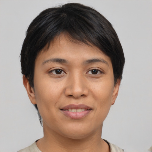 Joyful asian young-adult female with short  brown hair and brown eyes