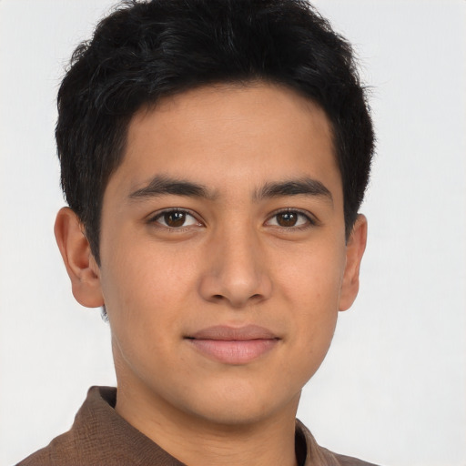 Joyful latino young-adult male with short  brown hair and brown eyes