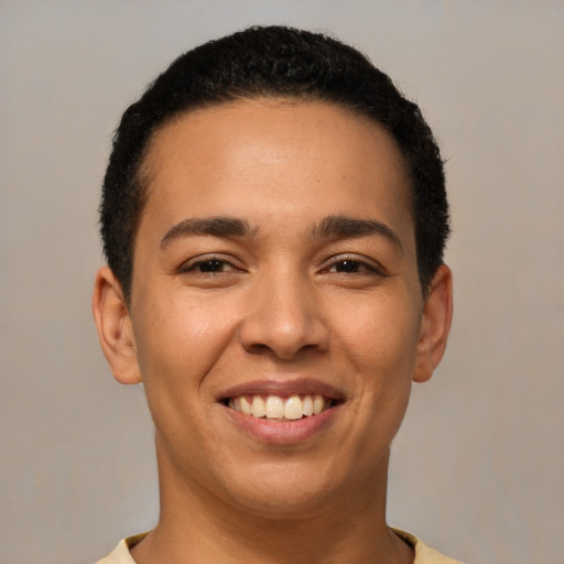 Joyful latino young-adult male with short  brown hair and brown eyes