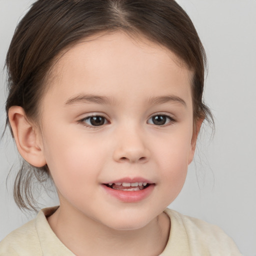 Joyful white child female with medium  brown hair and brown eyes