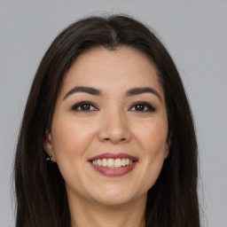 Joyful white young-adult female with long  brown hair and brown eyes