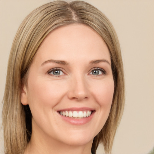 Joyful white young-adult female with medium  brown hair and green eyes