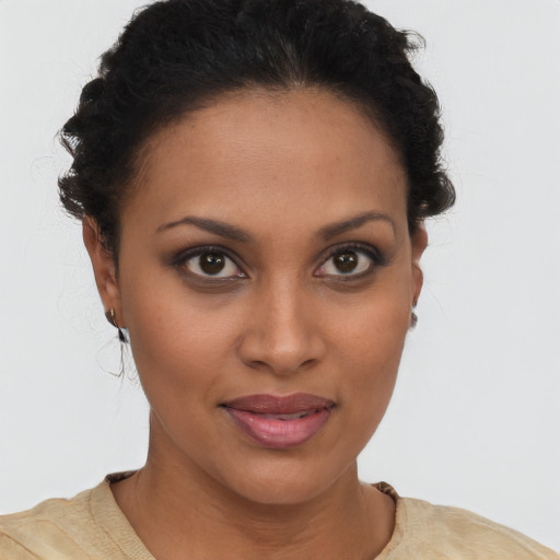 Joyful latino young-adult female with short  brown hair and brown eyes