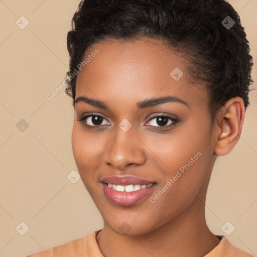 Joyful black young-adult female with short  brown hair and brown eyes