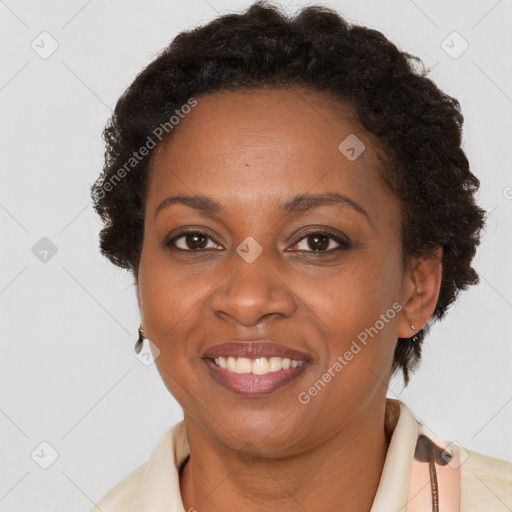 Joyful black adult female with short  brown hair and brown eyes