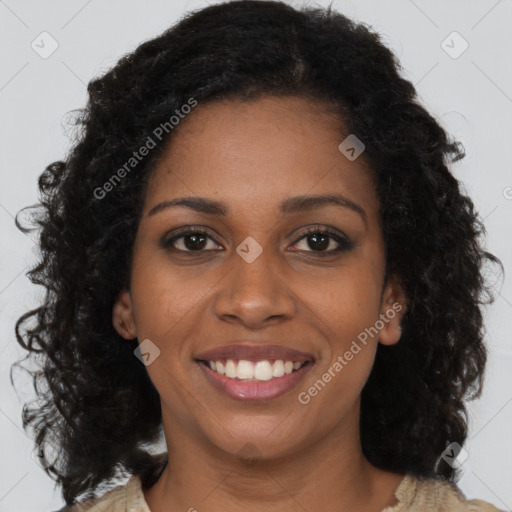 Joyful black young-adult female with long  brown hair and brown eyes