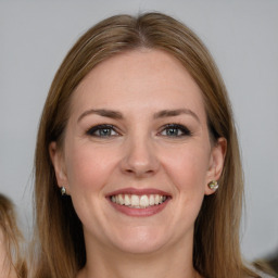 Joyful white young-adult female with long  brown hair and grey eyes