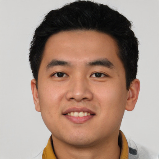 Joyful asian young-adult male with short  black hair and brown eyes
