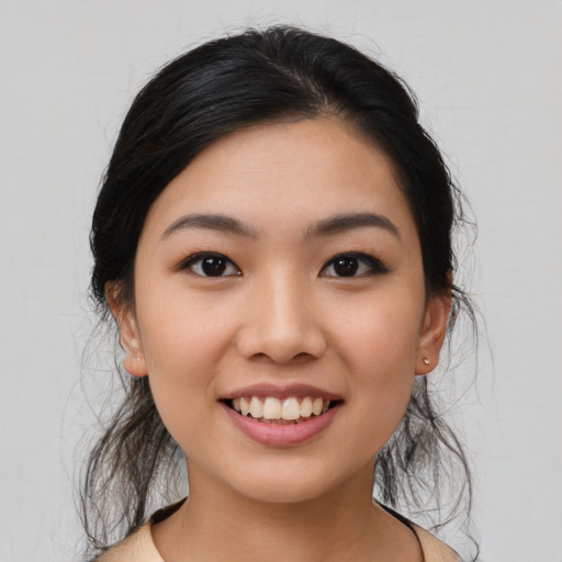 Joyful asian young-adult female with medium  black hair and brown eyes