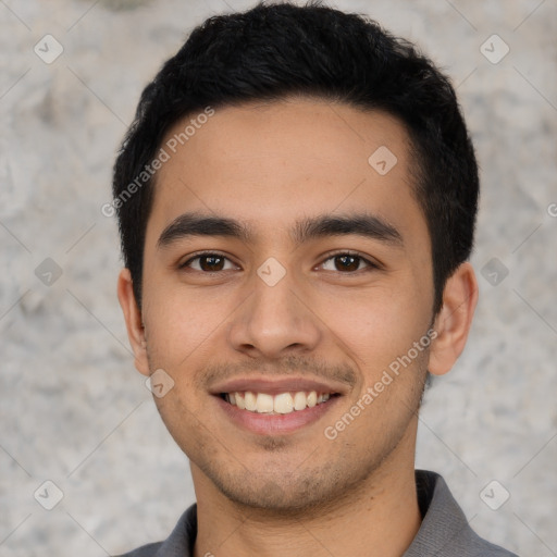 Joyful latino young-adult male with short  black hair and brown eyes