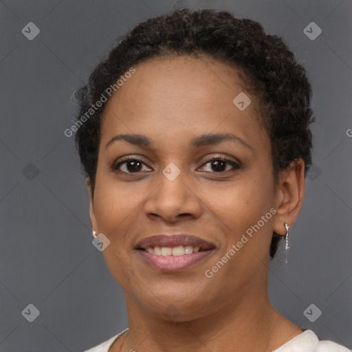 Joyful black young-adult female with short  brown hair and brown eyes