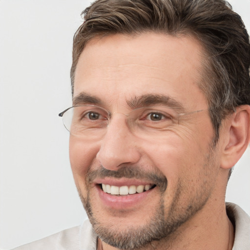 Joyful white adult male with short  brown hair and brown eyes