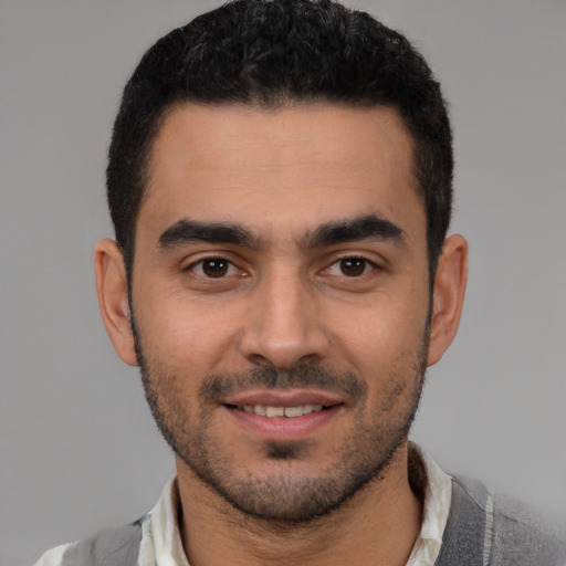 Joyful white young-adult male with short  black hair and brown eyes