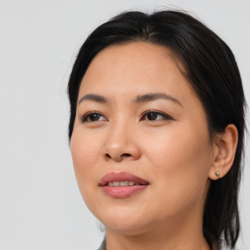 Joyful asian young-adult female with medium  brown hair and brown eyes