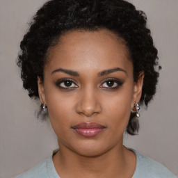 Joyful black young-adult female with medium  black hair and brown eyes