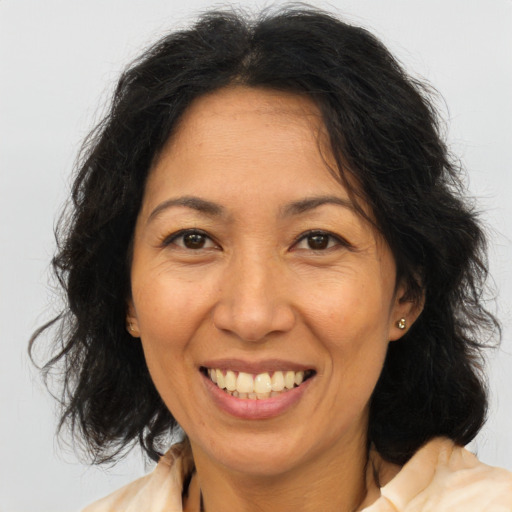 Joyful asian adult female with medium  brown hair and brown eyes