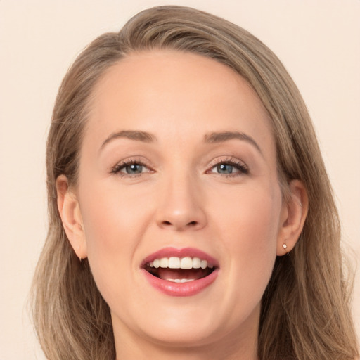 Joyful white young-adult female with long  brown hair and brown eyes