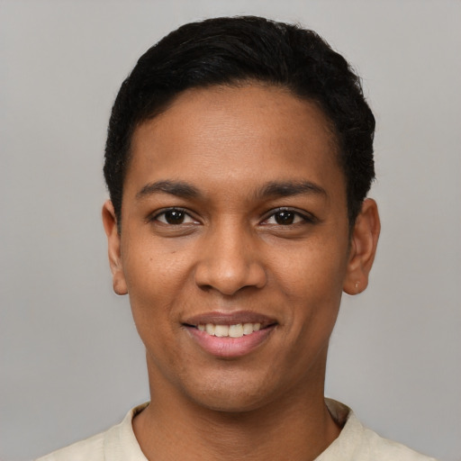 Joyful latino young-adult male with short  black hair and brown eyes