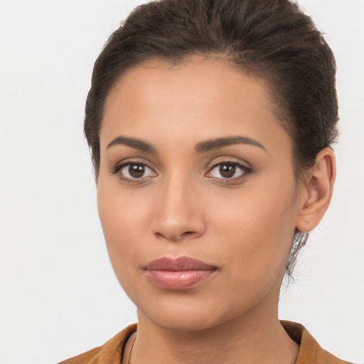 Joyful latino young-adult female with short  brown hair and brown eyes