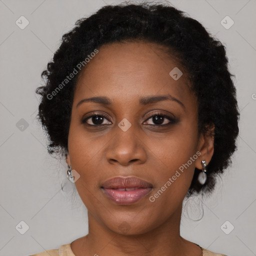 Joyful black young-adult female with long  brown hair and brown eyes