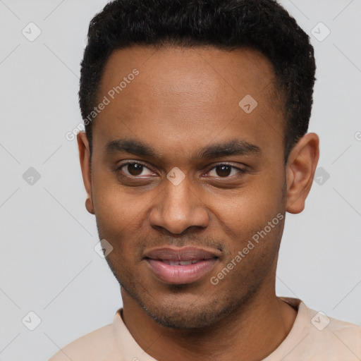 Joyful black young-adult male with short  brown hair and brown eyes