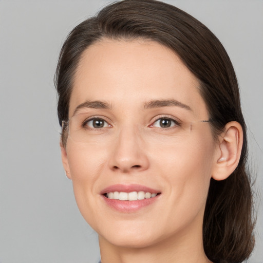 Joyful white young-adult female with medium  brown hair and brown eyes