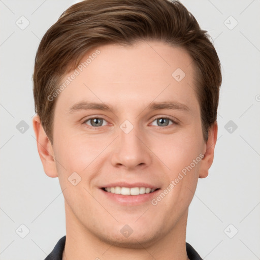 Joyful white young-adult male with short  brown hair and grey eyes