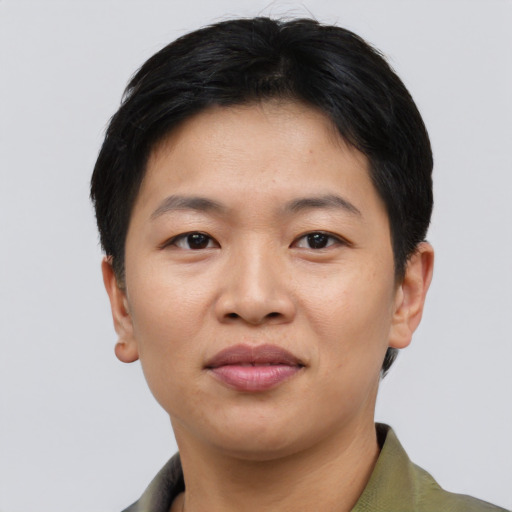 Joyful asian young-adult female with short  black hair and brown eyes