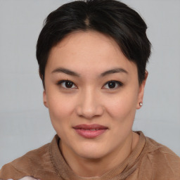 Joyful asian young-adult female with short  brown hair and brown eyes