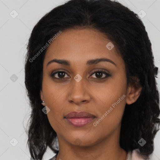 Joyful black young-adult female with long  brown hair and brown eyes