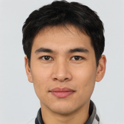 Joyful asian young-adult male with short  black hair and brown eyes