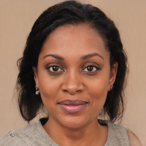 Joyful black young-adult female with medium  black hair and brown eyes