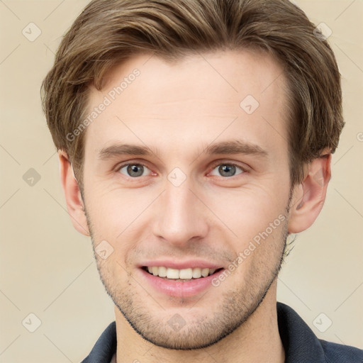 Joyful white young-adult male with short  brown hair and grey eyes