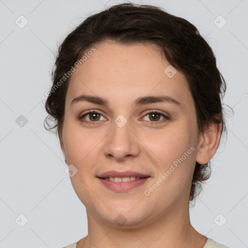 Joyful white young-adult female with short  brown hair and brown eyes