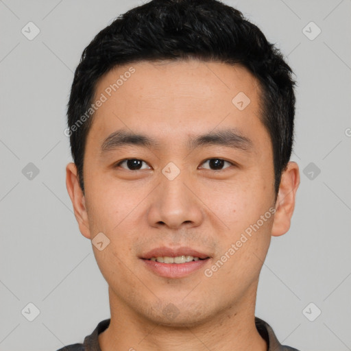 Joyful asian young-adult male with short  black hair and brown eyes