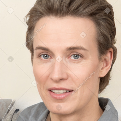 Joyful white adult female with short  brown hair and grey eyes