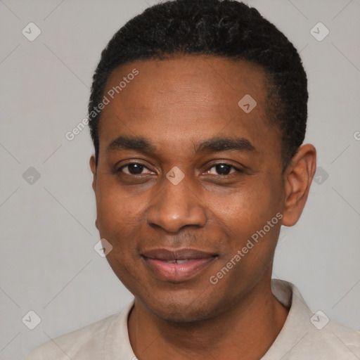 Joyful black young-adult male with short  black hair and brown eyes