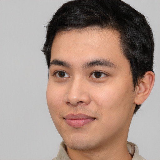 Joyful asian young-adult male with short  black hair and brown eyes