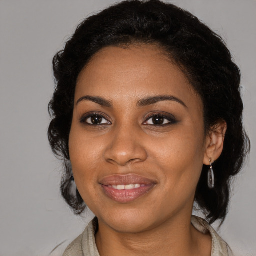 Joyful black young-adult female with medium  black hair and brown eyes