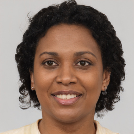 Joyful latino young-adult female with short  black hair and brown eyes