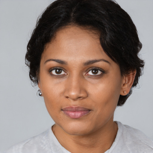 Joyful black young-adult female with medium  brown hair and brown eyes
