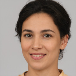 Joyful white young-adult female with medium  brown hair and brown eyes